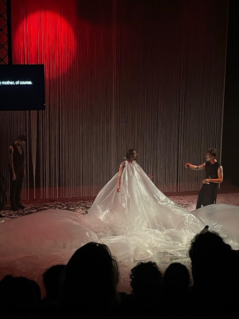 Performer wearing a sweeping translucent costume on the Bacchae Underworld stage